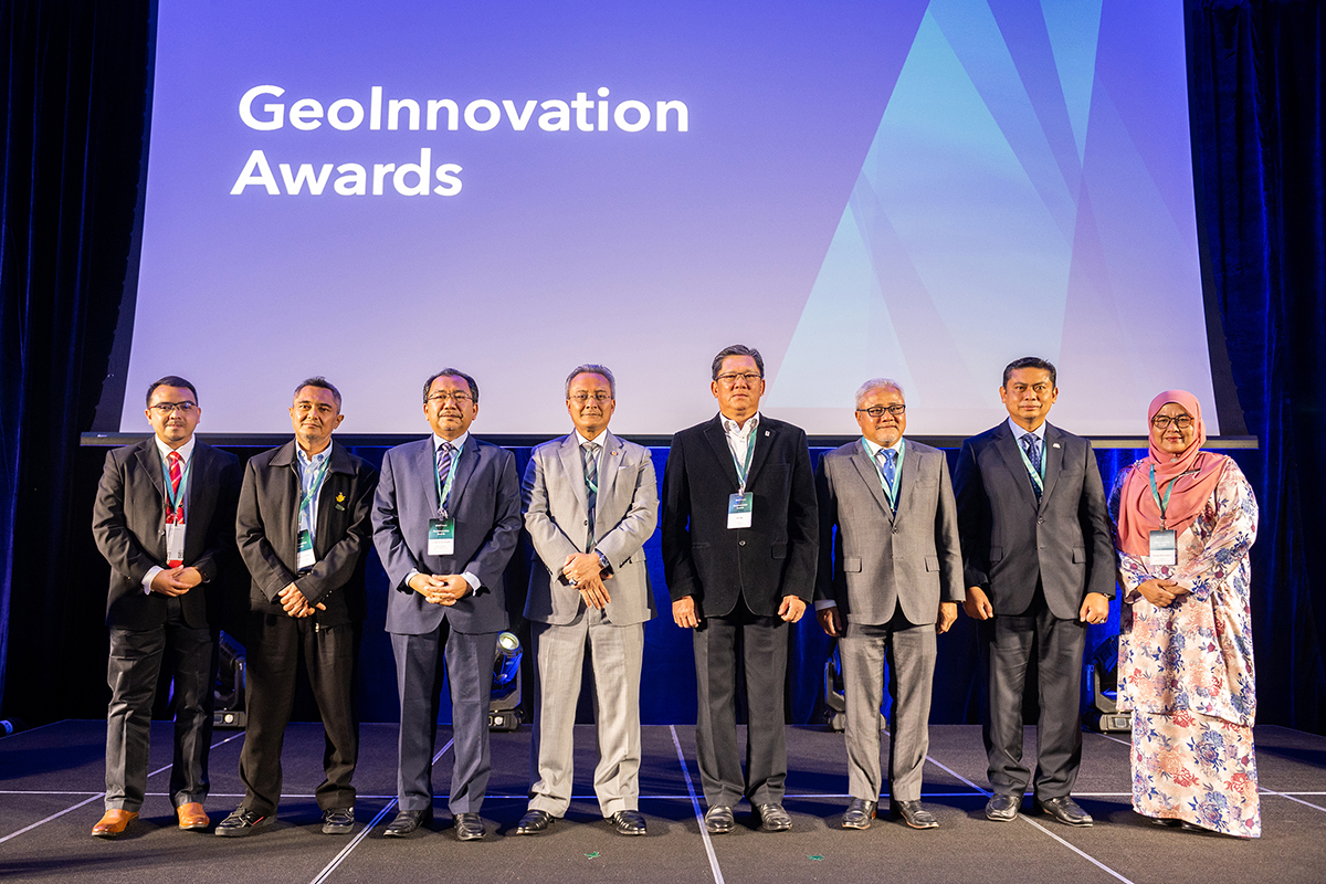 People standing to receive GeoInnovation Awards on stage