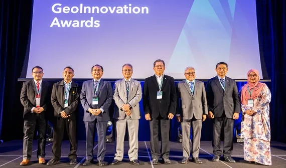 People standing on stage to receive an AWARD